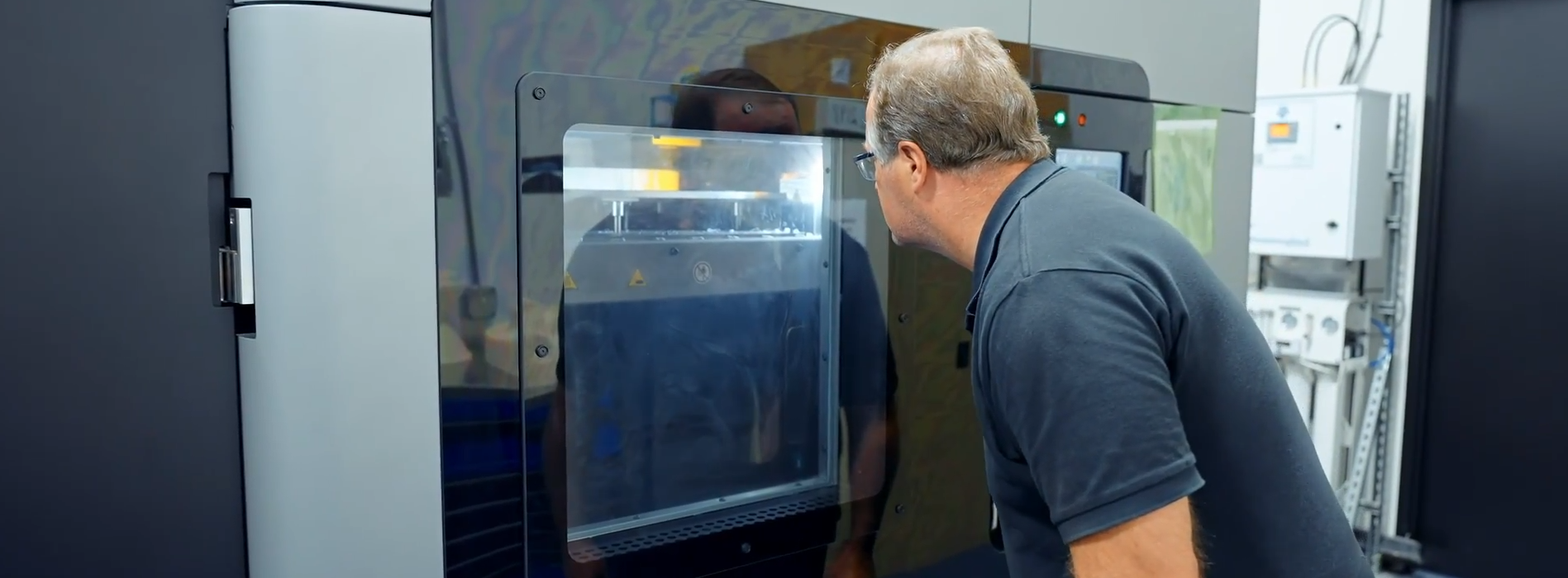 Person looks at Stratasys F900 3D Printer